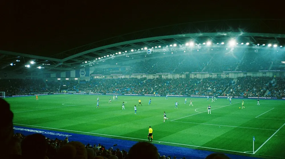 Floodlit stadium during a live match